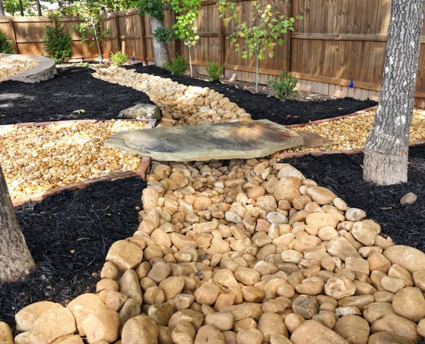 stone slab bridge over dry creek bed